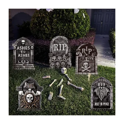A set of grey moulded headstones staked in a lawn