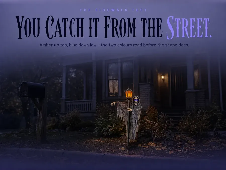 The ghoul seen small from the public sidewalk, its amber lantern and blue eyes the brightest thing on the lawn