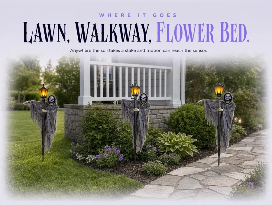 A daylit garden showing the lawn edge, the planted border and the walkway strip, one stake unlit in the bed