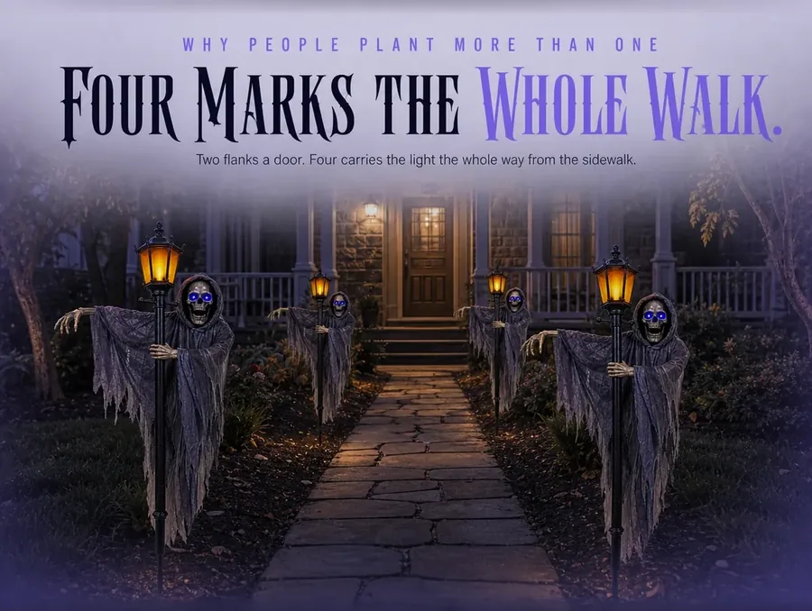 A front walkway lined with four lit gaslight ghouls leading to a warm front door