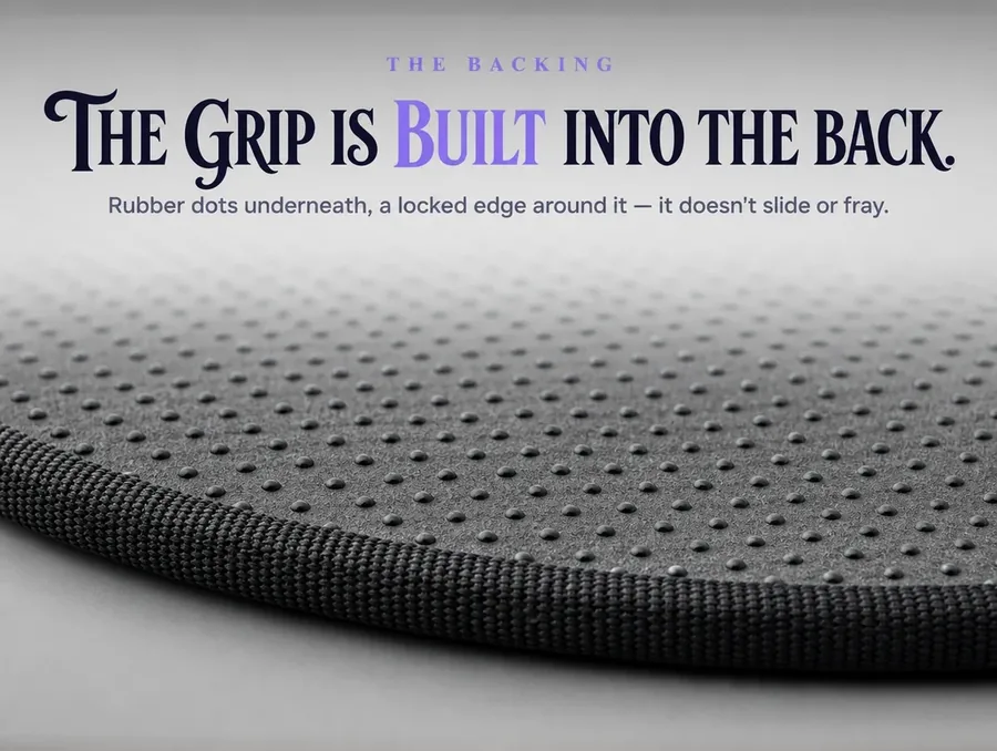 Macro of the rug's underside showing rubber non-slip dots and the locked, bound edge trim.