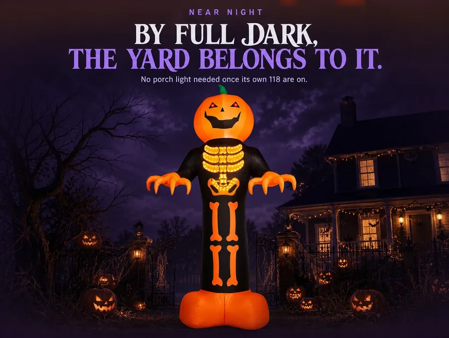 The reaper lit almost entirely by its own glow as the yard sinks into near-full night.