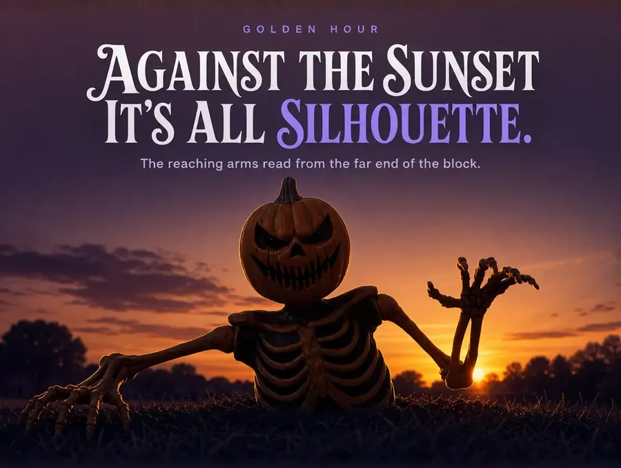 The groundbreaker in silhouette against a deep orange sunset sky.