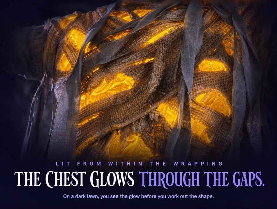 Macro of the mummy's wrapped chest with amber light glowing through gaps in the cloth.